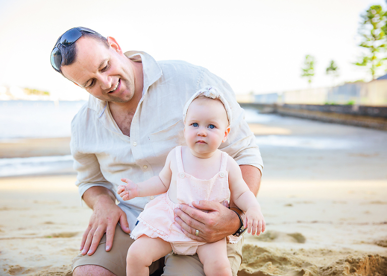 Family photographer taking photos at the beach