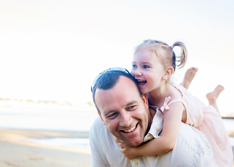 Family photographer taking photos at the beach