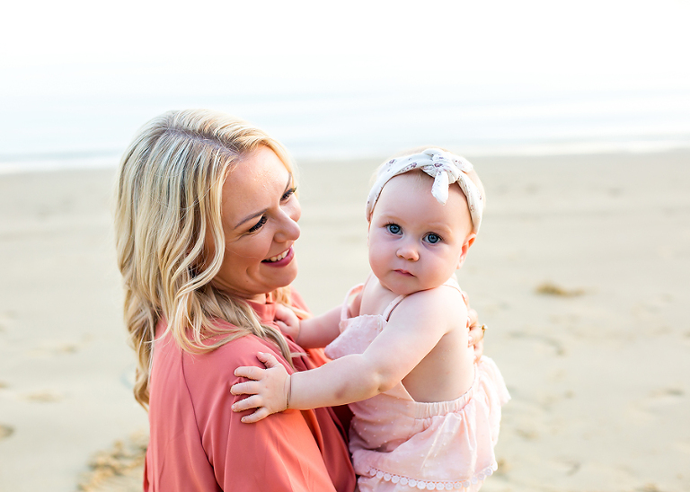 Family photographer taking photos at the beach